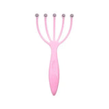 a pink plastic hair brush with two eyes