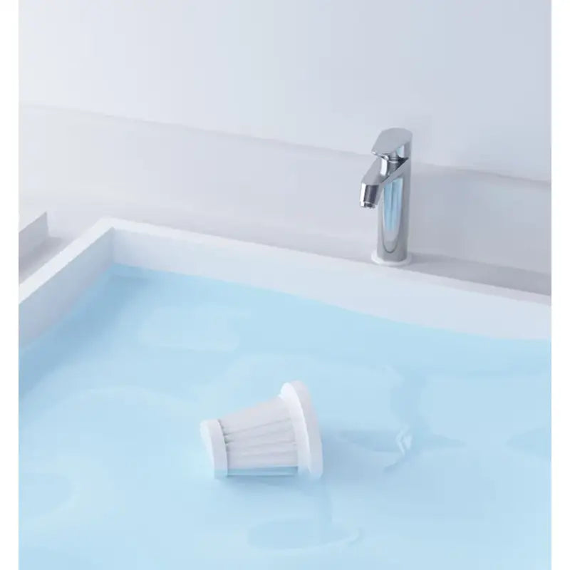 a white sink with a blue water in it
