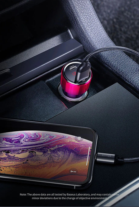 Cylindrical pink car charger plugged into a vehicle’s power outlet.