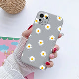 someone holding a phone case with a daisy pattern on it