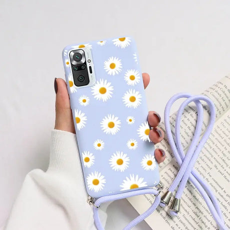 someone holding a phone case with a flower pattern on it