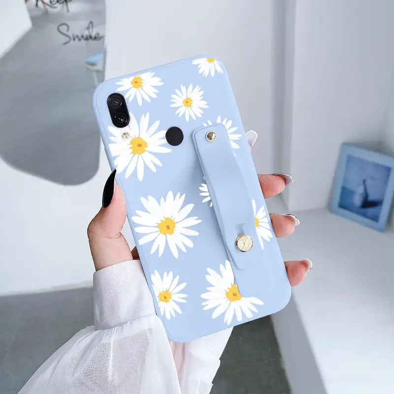 someone holding a phone case with a flower design on it