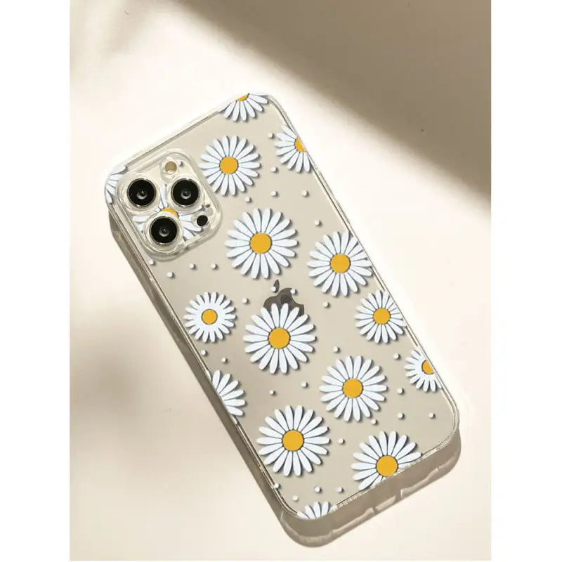 a white daisy phone case with yellow and white flowers