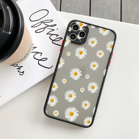 Daisy iphone case with a coffee cup on a table