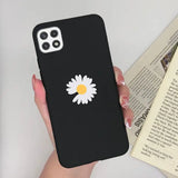 a woman holding a phone case with a daisy on it