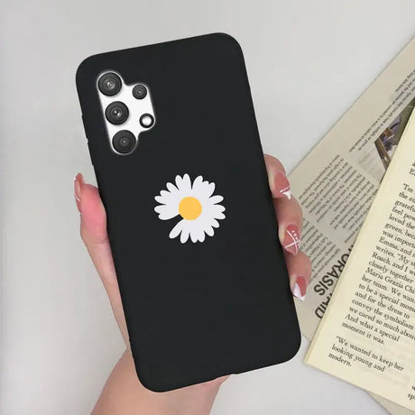 a woman holding a phone case with a daisy on it