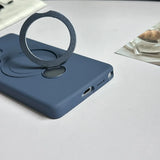 A dark blue phone case with a silver, circular, magnetic ring holder.