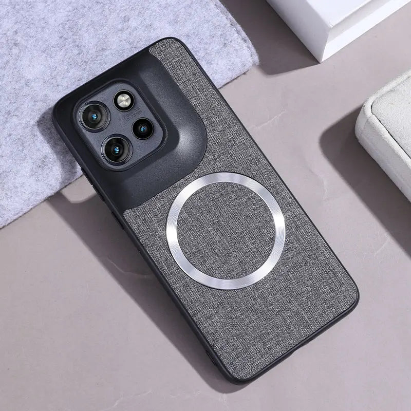 A dark gray fabric phone case with a black camera module section and an integrated silver magnetic ring.