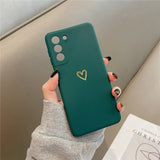Dark green phone case with a gold heart design.