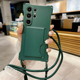 Dark green smartphone case with a card holder and an attached crossbody strap.