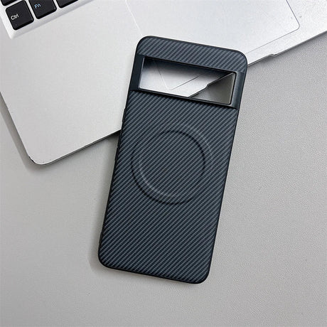 A dark grey carbon fiber pattern phone case with a Magsafe ring and a horizontal cutout for the camera module.