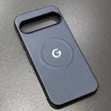 A dark grey carbon fiber pattern phone case with a camera cutout and a visible G logo.