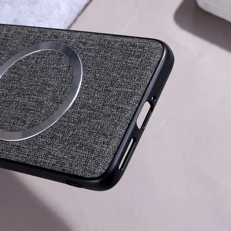 A dark grey fabric-textured phone case with a silver magnetic ring.