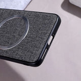 A dark grey fabric-textured phone case with a silver magnetic ring.