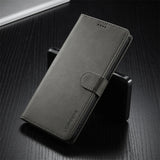 Dark grey faux leather wallet phone case with a magnetic clasp.