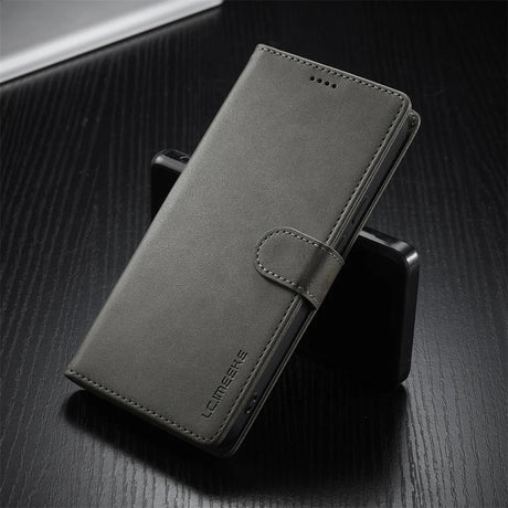 Dark grey faux leather wallet phone case with a magnetic clasp.