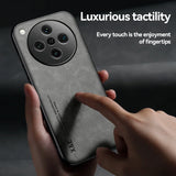 A dark grey smartphone with a circular, multi-lens camera module and a textured, matte back.