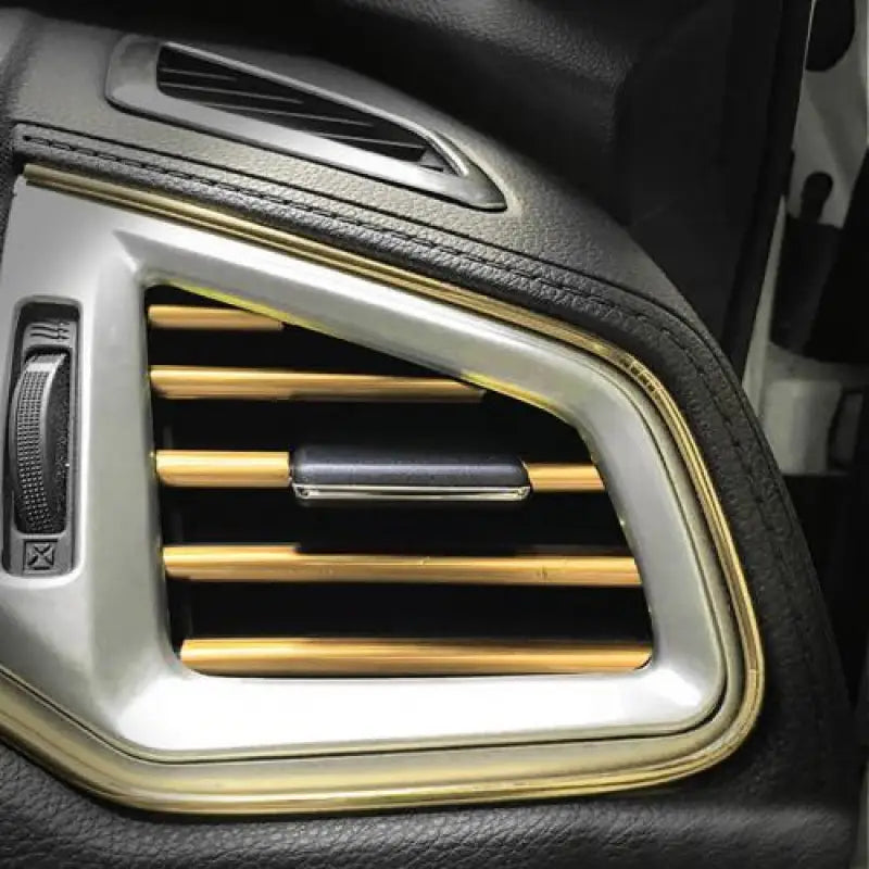 a car dashboard with a gold and black interior