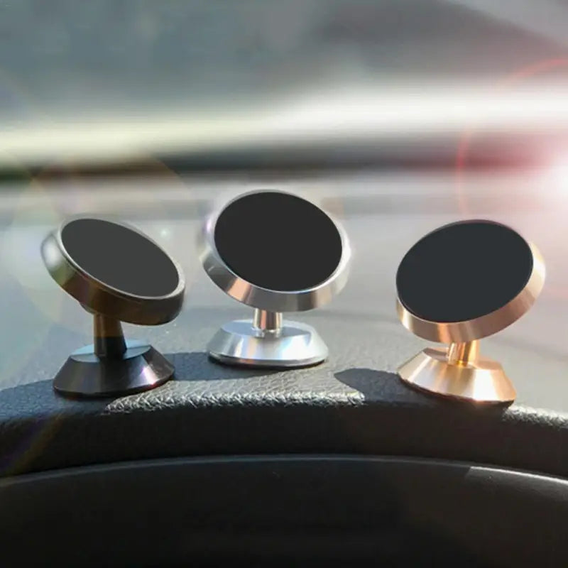 two metal knobs on the dashboard of a car