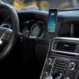 the interior of a car with a phone in the center