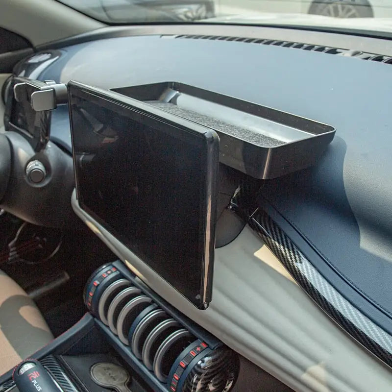 the dashboard of a car with a phone holder