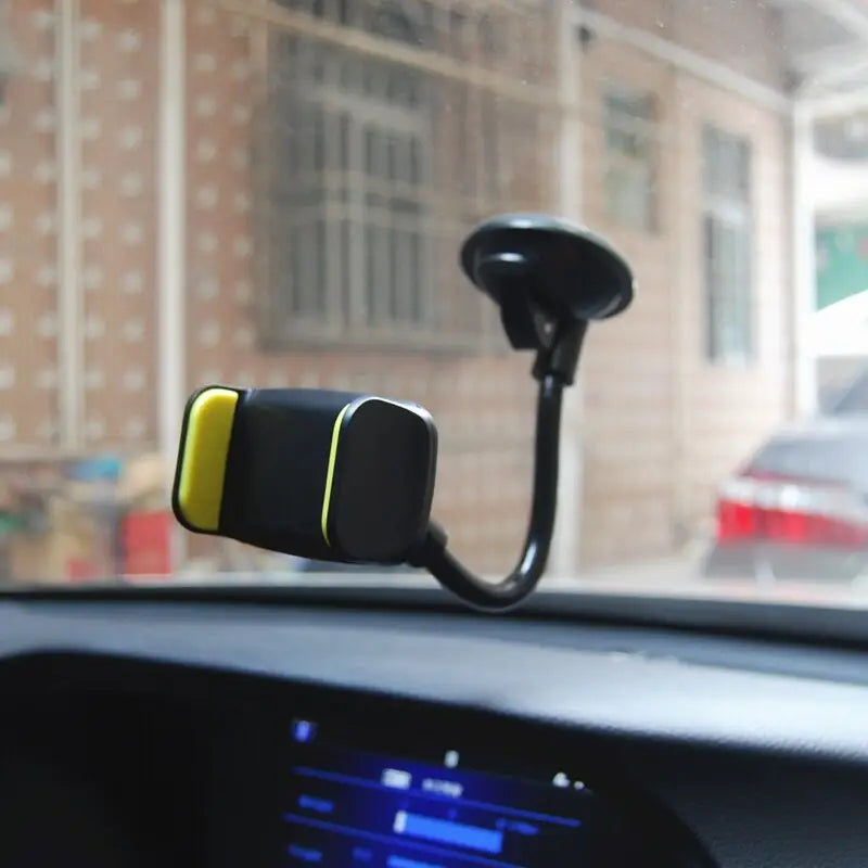 a car dashboard with a yellow and black device attached to the dashboard