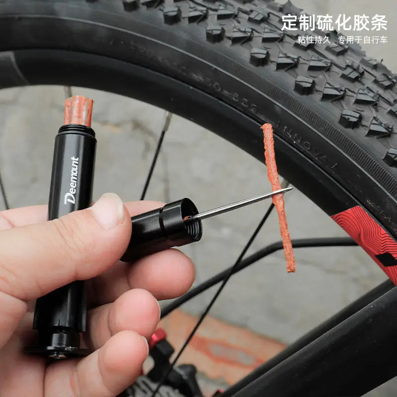 a hand holding a bicycle tire with a wren