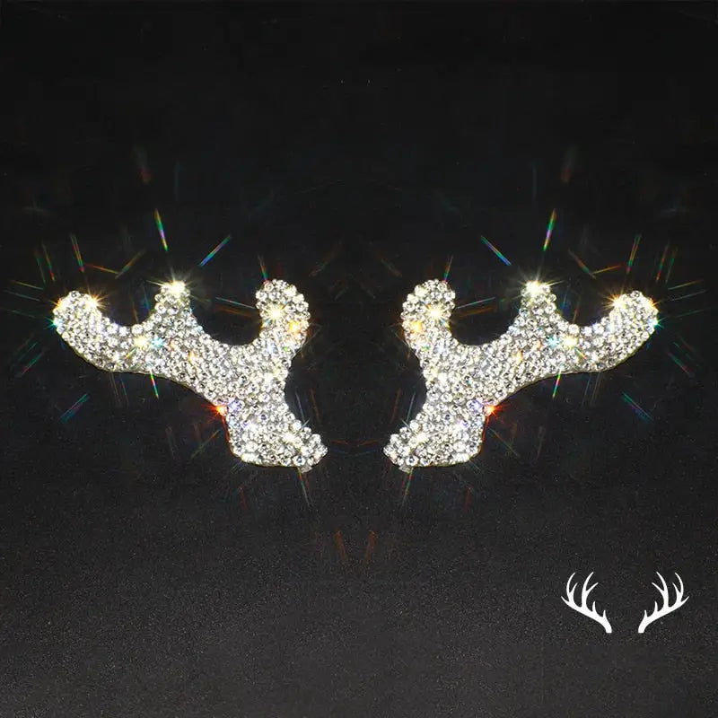 a pair of reindeer head stud earrings with rhine