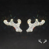 a pair of reindeer head stud earrings with rhine