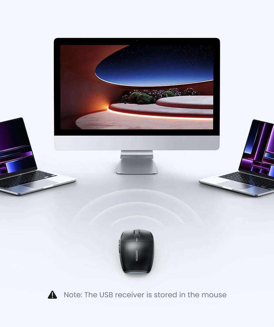 Desktop computer with a large screen flanked by two laptops and a wireless mouse in front.