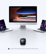 Desktop computer with a large screen flanked by two laptops and a wireless mouse in front.
