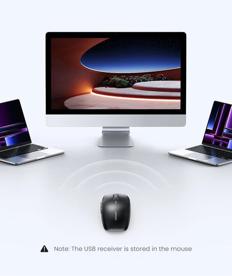 Desktop computer with a large screen flanked by two laptops and a wireless mouse in front.