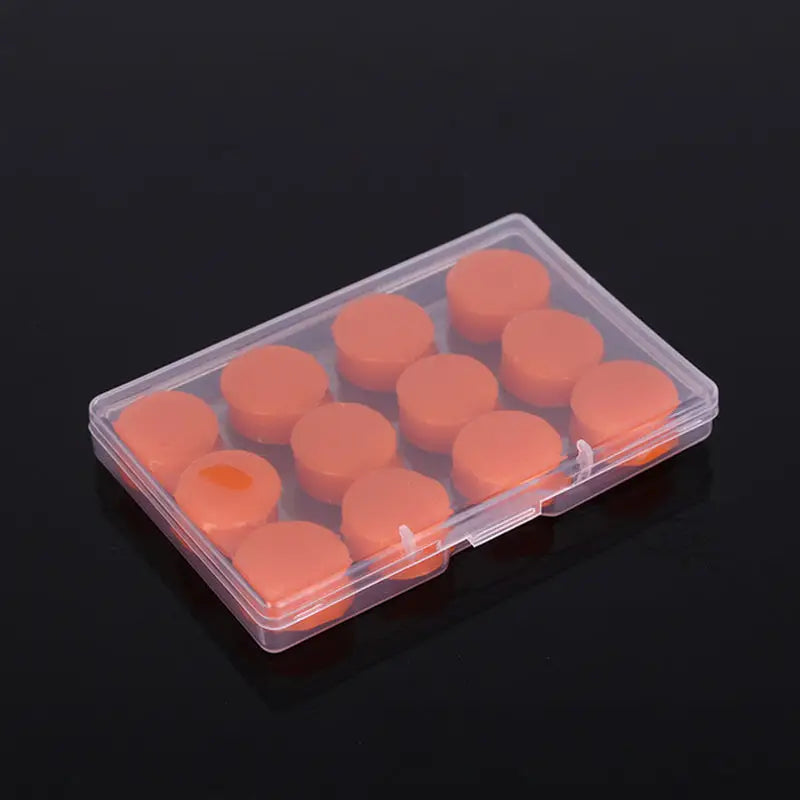 a small plastic box filled with orange candles