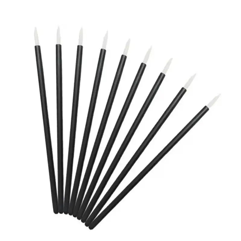 a set of six black and white brushes with white tips