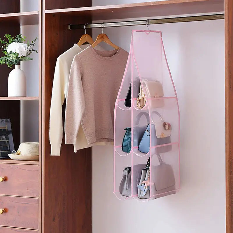 a wooden closet with a pink hanging organizer