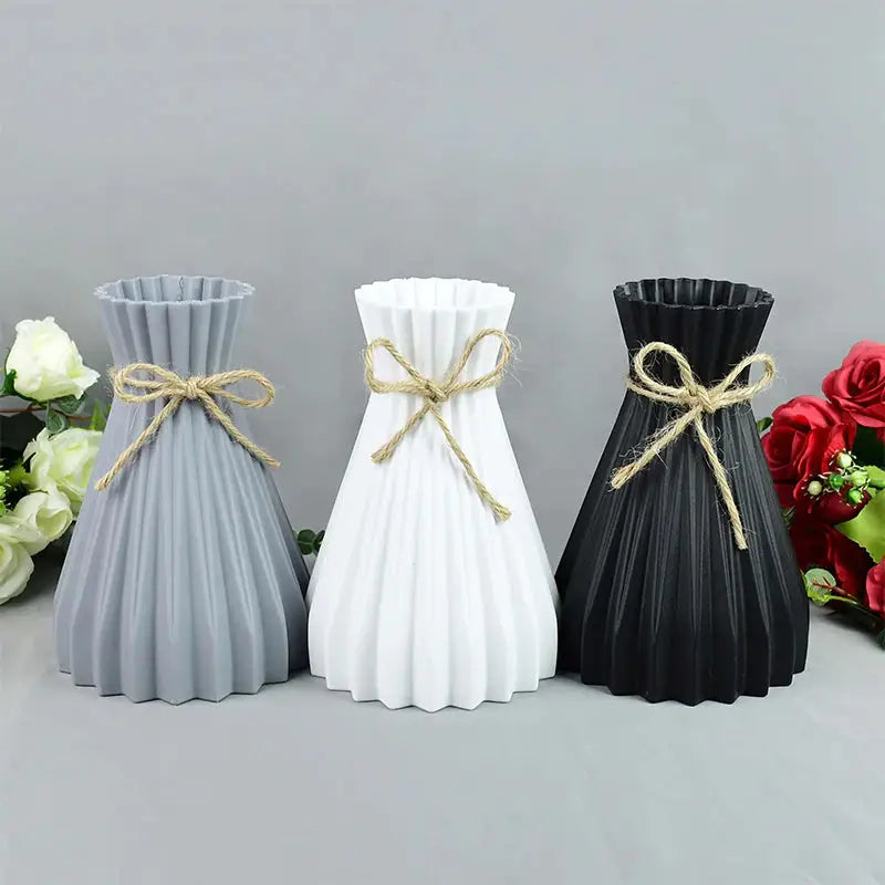 three vases with a ribbon tied around them