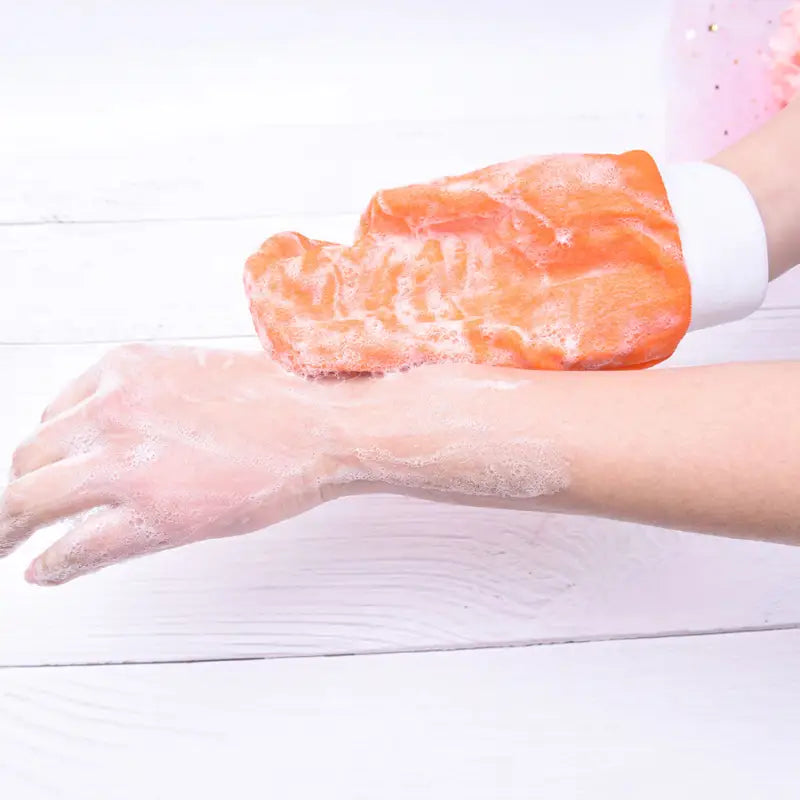 a woman washing her hands with soap