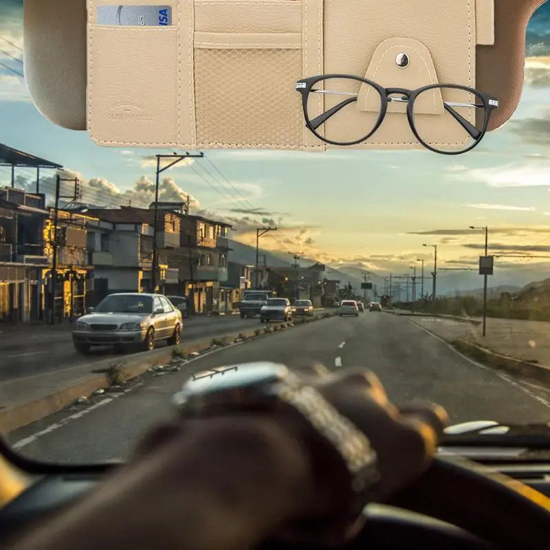 a person driving a car with a pair of glasses on the dashboard