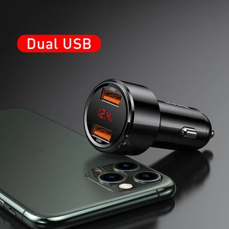 Dual USB car charger with digital voltage display next to a smartphone.