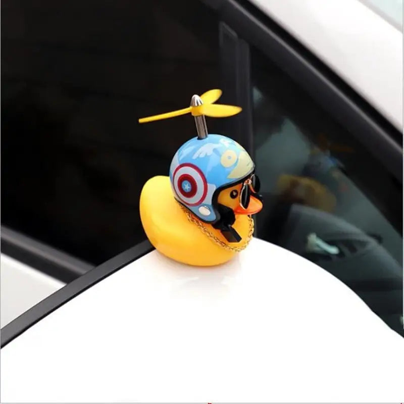 a duck with sunglasses on top of a car