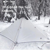 arafed tent in the snow with a tree in the background