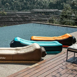 a pool with a large inflatable and a lounge chair
