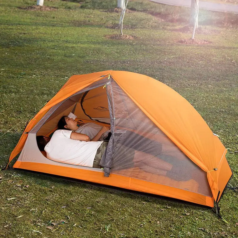 a man sleeping inside a tent
