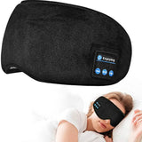 a woman sleeping in bed with a black eye mask