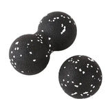 a pair of black and white polka dot ball earrings