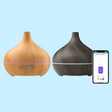 Essential oil diffusers with a smartphone displaying a control app.