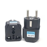a black travel adapt plug with a white background