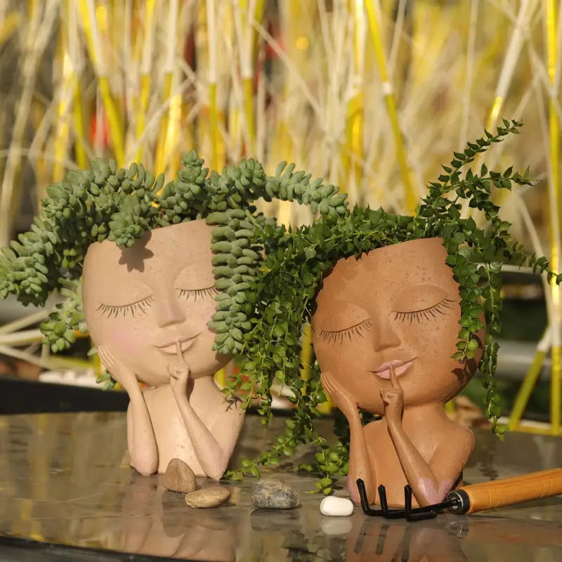 two clay sculptures of a couple kissing