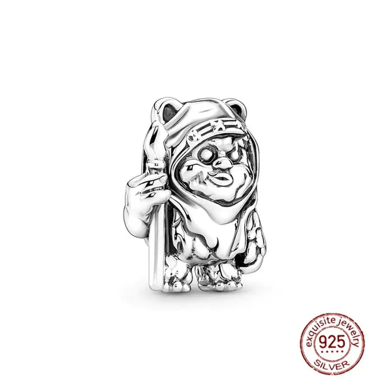 a silver charm with a bear holding a baseball bat