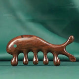 there is a wooden comb with a cat shaped design on it
